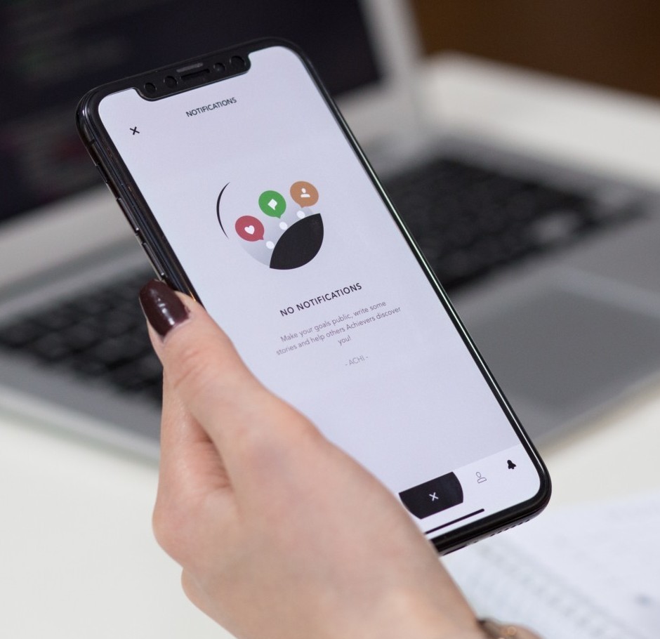 Photo of a woman working with a phone at her desktop Photo by freestocks.org on Unsplash